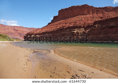 Cold green water of the Colorado River in the red rocks of the desert