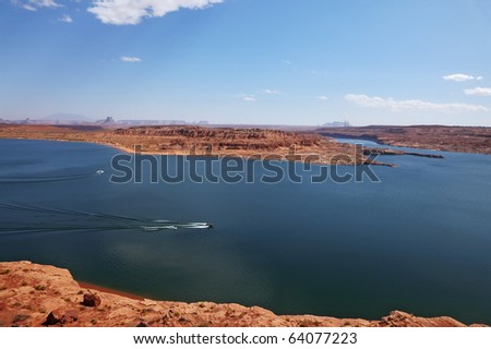 . Superb huge and beautiful Lake Powell. Motorboats cut the smooth water of the lake