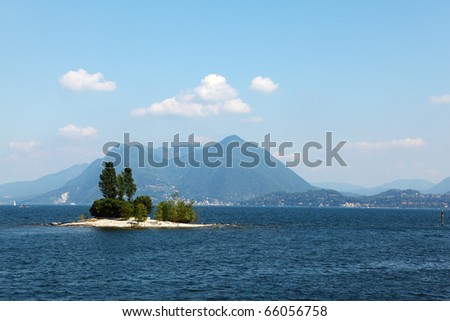 Charming little island in Lake Maggiore, photographed with a tourist pleasure boat