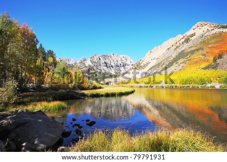 North Lake. Mountains covered with red and yellow bushes are reflected in the blue water lakes