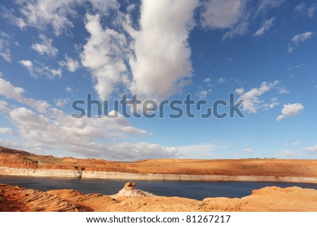 Red stone desert and the bright blue water. Lake Powell in a beautiful sunny day