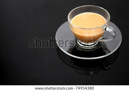 Clear cup of coffee on dark background