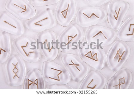 Glass rune stones with gold colored runes on them