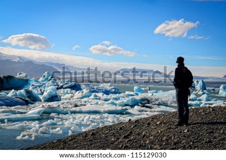 Ice lagoon and iceberg lake and person\'s silhouette