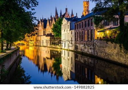 Water Canal, Medieval Houses And Bell Tower At Night, Bruges
