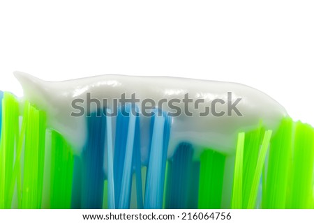 Green-blue toothbrush with toothpaste isolated on white background