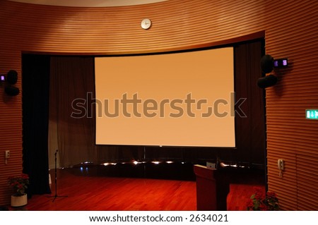 The interior of a theater, the stage and screen