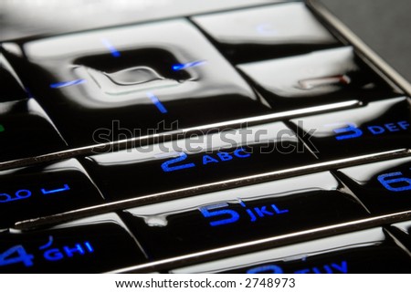 Close up shot of blue mobile keypad under dark environment