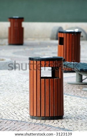 Three wooden litter bins in public area