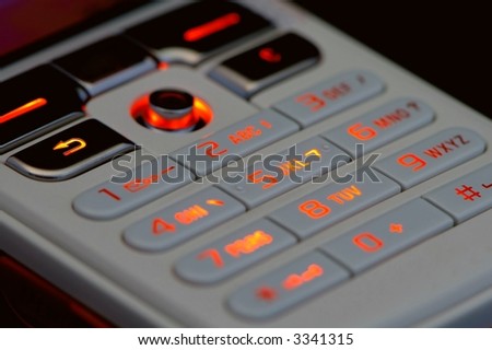 Close up shot of mobile keypad with light under dark