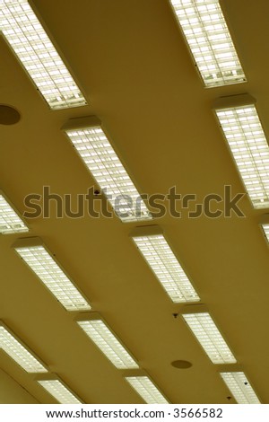 Rows of fluorescent lamps of office ceiling
