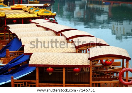 Line of boats anchored at the pier of Qinhuai river, the area of Confucius temple, in Nanjing, China