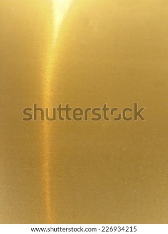 Part of a golden metal surface-divided into two sections
