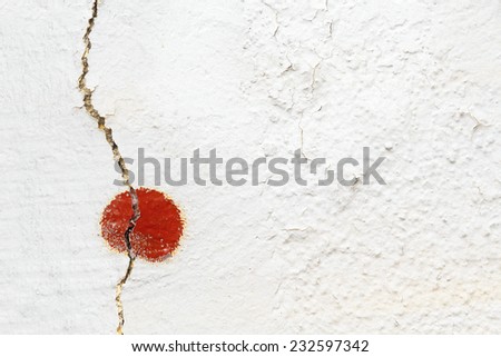 Old cracked plastered white wall with red detail - divided  into two sections