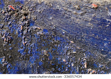 Small part of plastered hoarse,scratched and peeled surface area with blue and black paint -Abstract background-Close up