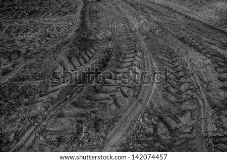 black and white wheel tracks on dirt