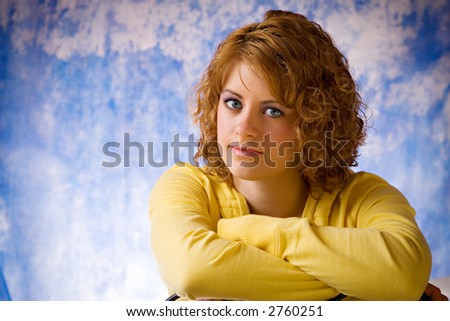 Young woman in yellow shirt with blue background