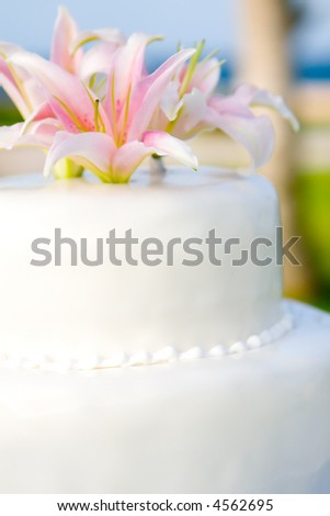stock photo Whites Wedding Cake with Casablanca Lily flower topper