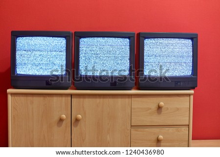 No signal just noise on three old TV screens