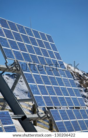 Big cluster of solar panels on a mountain peak