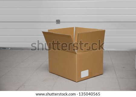 Open cardboard box in a garage