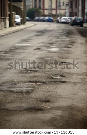 Very bad quality road with potholes