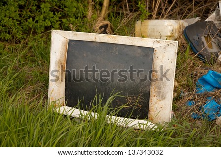 Discarded old TV set on a field