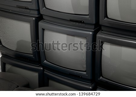 A pile of old tv sets