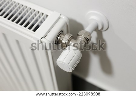 Heating radiator detail against orange wall