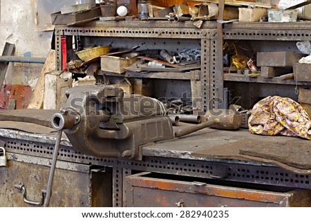 Messy workshop table with vise and old tools