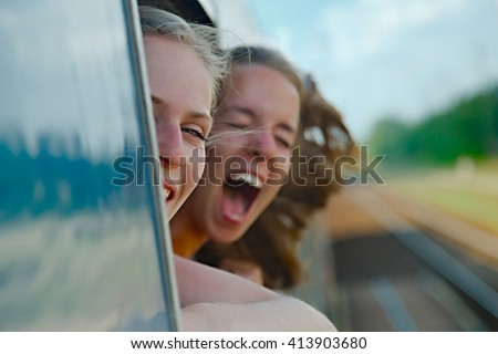 Two girls enjoying train travel
