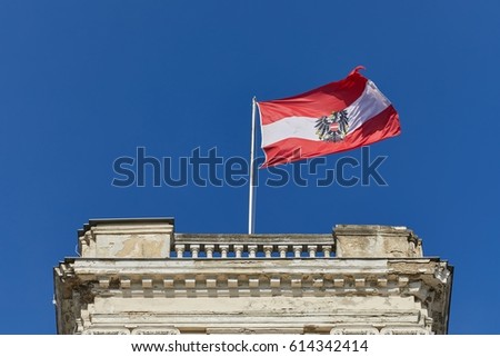 Austrian flag waving against blue sky