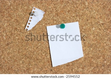 A piece of paper pinned to a corkboard. Add your own text