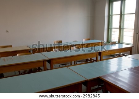 Old, empty classroom with plain white walls