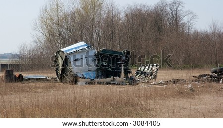 Old, small aircraft wreck on a dry field