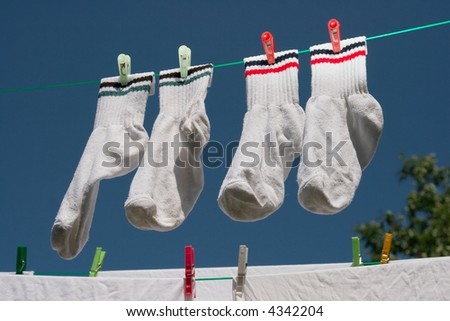 White clothes hung out to dry under clear blue sky