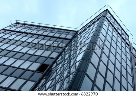 Part of a modern office building against the sky