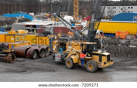 Construction site with heavy machines and containers