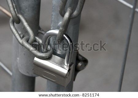 Metal gate locked by a padlock and chain