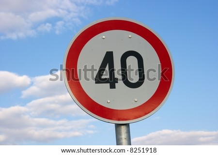 Speed limit traffic sign against blue sky