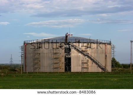 Big round oil silo on a field