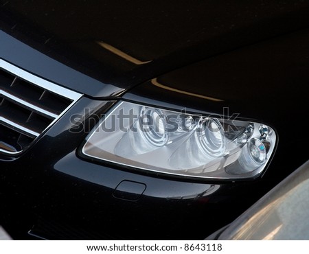 Closeup of the headlights of a black car