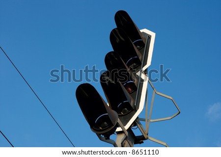 Railway traffic signal light against clear blue sky