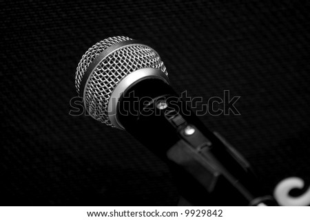 Microphone in front of the black textile on a guitar amp