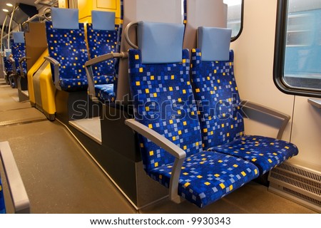 Interior of a train wagon with empty seats