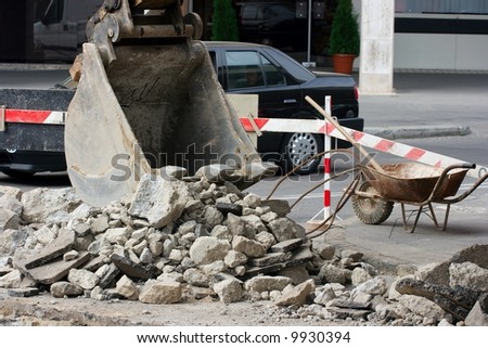 Construction on an urban street, excavator at work