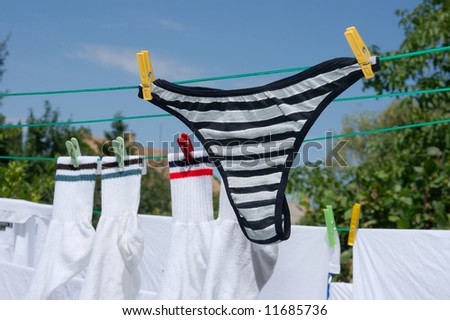 Wet clothes drying on a rope in the garden