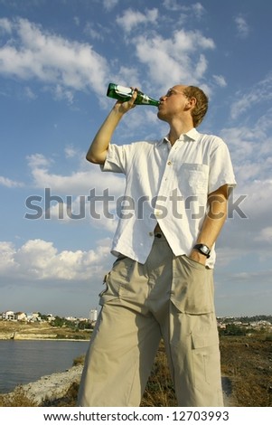 Man drinking beer in hot weather
