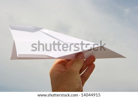 Paper plane in human hand
