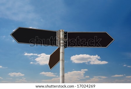 Empty direction sign boards against blue sky